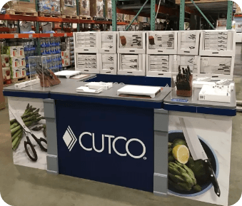 a cutco counter in a warehouse with knives on it