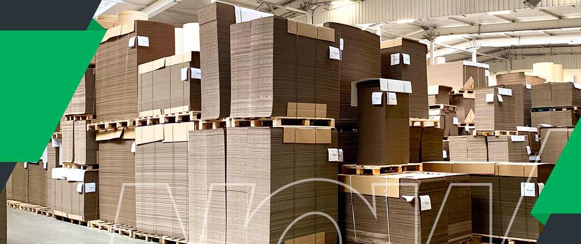 a warehouse filled with lots of cardboard boxes and pallets