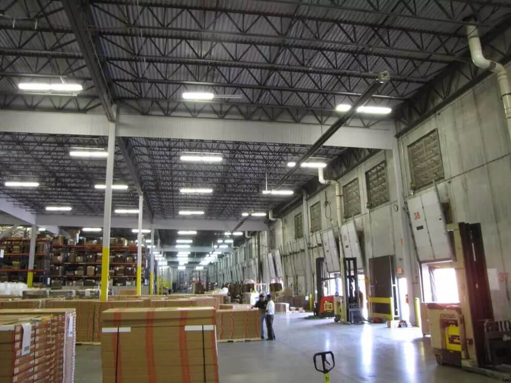 a large warehouse filled with lots of boxes and a forklift